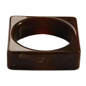 Detail view of a vintage marbled brown resin wide bangle showing its glossy finish