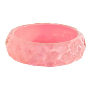 Detailed close-up view of a pink vintage wide resin bangle with unique marbled texture.