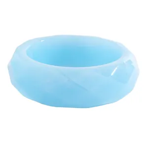 Detailed view of a faceted light blue resin wide bangle with a semi-transparent vintage style