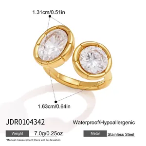 Detailed view of gold plated stainless steel ring with ribbed settings and clear gems