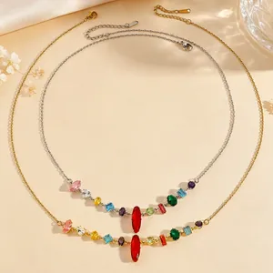 Detail of elegant gold and silver necklaces featuring vibrant multi-colored gemstones.