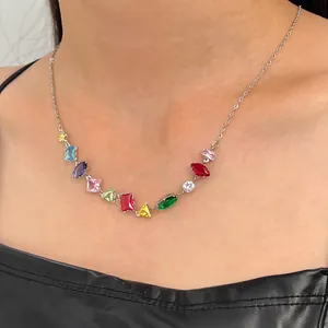 Close-up detail of a colorful zircon necklace featuring vibrant multi-shaped rainbow gemstones.
