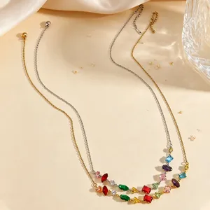 Close-up of elegant gold and silver necklaces with vibrant colorful zircon gemstones