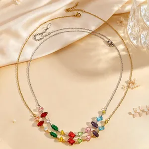 Detailed view of gold and silver necklaces featuring vibrant multi-color gemstones on silk.
