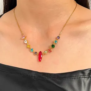 Detailed close-up view of a gold chain necklace featuring vibrant colorful gemstones