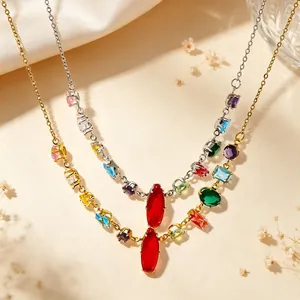 Macro detail of colorful gemstone necklace featuring red pendant and mixed metal chains
