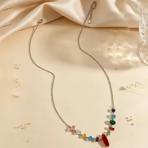 Detailed view of silver-toned necklace featuring vibrant multi-colored crystal gemstones