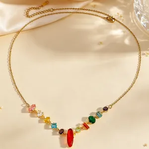 Close-up of elegant gold necklace with vibrant multi-colored zirconia stones.