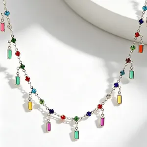 Detailed macro view of silver necklace featuring vibrant multi-colored baguette gemstones