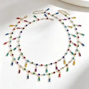 Detail view of colorful rectangle and round zircon gemstones on a layered necklace