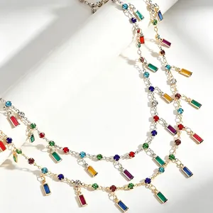 Detailed close-up of vibrant multi-colored gemstone necklaces with rectangular crystal drops