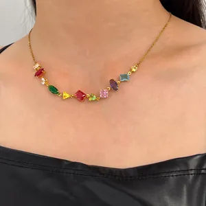 Elegant gold chain necklace featuring vibrant multi-color zircon gemstones on a model's neck