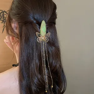 Close-up of a vintage Chinese style butterfly hair clip with embroidery and long golden tassels