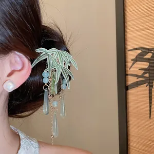 Elegant Hanfu hair clip with green bamboo embroidery and long beaded tassels on model