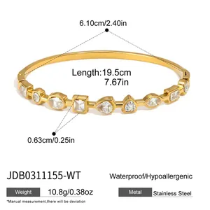 Detail of stainless steel bangle with multi-shape cubic zirconia in gold finish