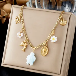 Detailed view of ocean-themed gold chain necklace with turtle and dolphin charms