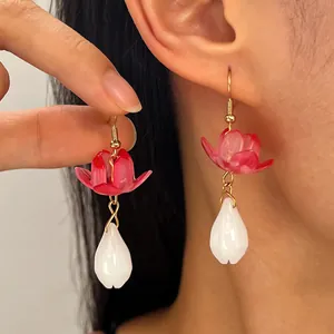 Close-up detail of New Chinese style lotus earrings with white teardrop pendant
