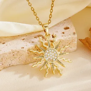 Close-up of elegant gold sunburst pendant necklace with sparkling cubic zirconia center