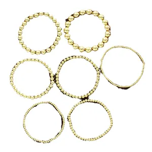 Juego de siete pulseras elásticas de cuentas CCB doradas con varios diámetros de cuentas para mujer