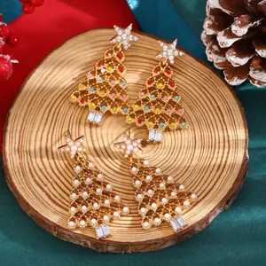 Close-up of gold-plated Christmas tree stud earrings with colorful beads and white pearls