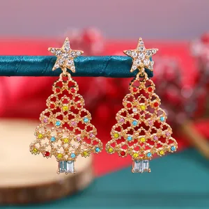 Detailed view of gold-tone Christmas tree stud earrings with vibrant colorful rhinestones