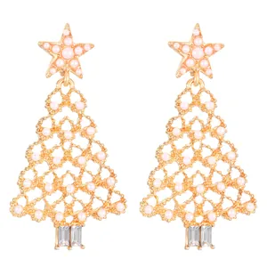 Detailed view of gold-tone Christmas tree earrings with pink pearls and crystals