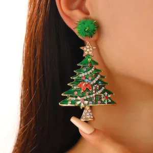Detailed close-up of a festive green Christmas tree dangling earring with colorful rhinestones