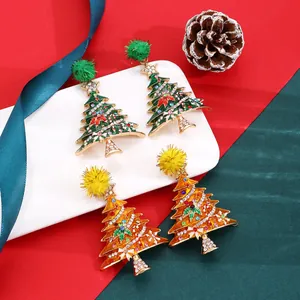Detailed view of rhinestone Christmas tree earrings with colorful crystals and pom-poms