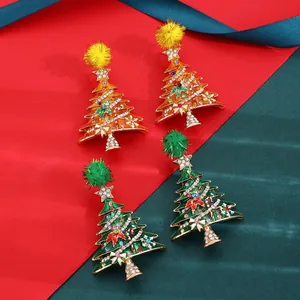Close-up detail of rhinestone-encrusted Christmas tree earrings with colorful pom-poms