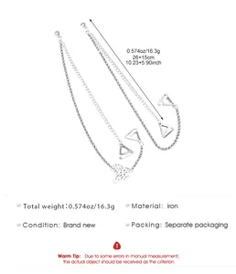 Detail showing silver rhinestone bra straps with butterfly charm and iron material specifications