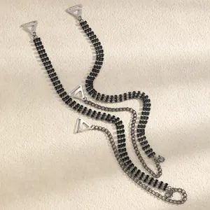 Detail of elegant black rhinestone decorative bra straps with silver-tone metal hooks