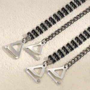 Close-up of elegant double-row black rhinestone bra straps with silver metal hooks