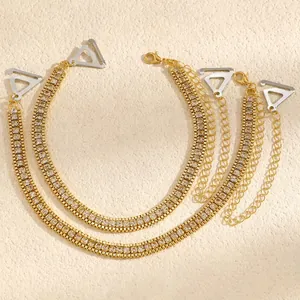 Detailed view of elegant gold-tone rhinestone bra straps with silver clips and adjustable chains.