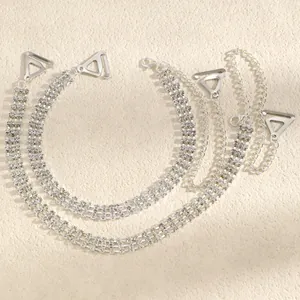 Detailed view of silver triple-row rhinestone decorative bra straps with metal hooks