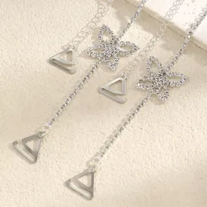 Detailed view of silver bra straps featuring elegant butterfly rhinestone charms and hooks
