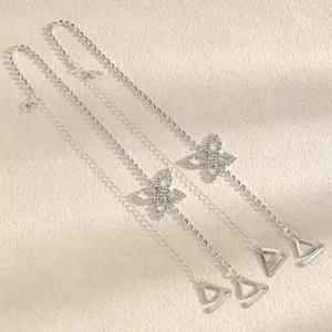 Detail view of elegant silver rhinestone bra straps with sparkling butterfly accents.