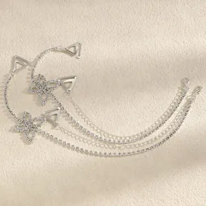 Detailed view of shimmering rhinestone flower bra straps with silver chain and metal clips.