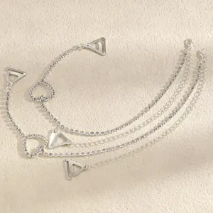 Close-up of silver rhinestone bra straps with heart accents and metal hooks