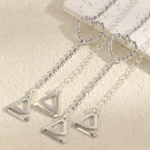 Close-up of elegant rhinestone heart-shaped decorative bra straps for off-shoulder outfits