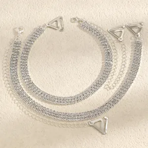 Macro detail of elegant three-row rhinestone bra straps with adjustable silver metal hooks