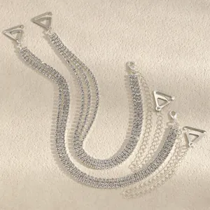 Detail view of sparkly triple-row rhinestone bra straps with adjustable silver chains