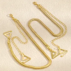 Detail shot of golden snake chain bra straps with adjustable link chains and triangle hooks