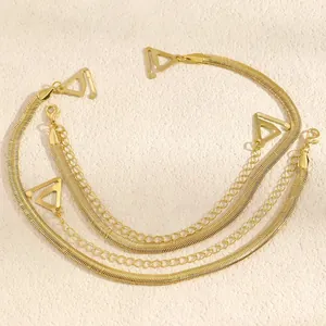 Detail view of stylish golden multi-layered snake chain bra straps with decorative links
