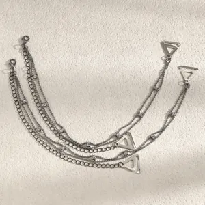 Detail of silver multi-layer decorative bra straps with rhinestones and triangular hooks
