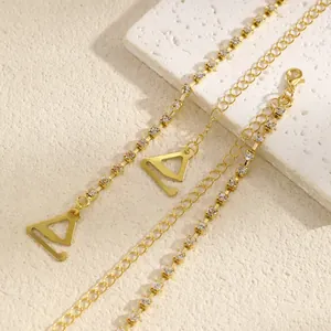 Detailed macro view of golden rhinestone bra straps with triangular hooks