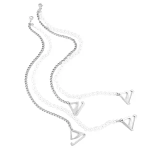Macro view of elegant silver chain and white pearl bra straps with V-shaped metal hooks.