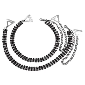 Detail view of fashionable silver-tone bra straps decorated with triple rows of black rhinestones.