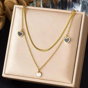 Double-layered gold-plated necklace with elegant heart pendants on link and snake chains