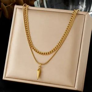 Double-layered gold plated necklace featuring a curb chain and geometric spike pendant