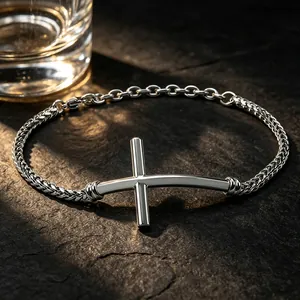 Close-up of minimalist stainless steel men's bracelet with horizontal cross charm